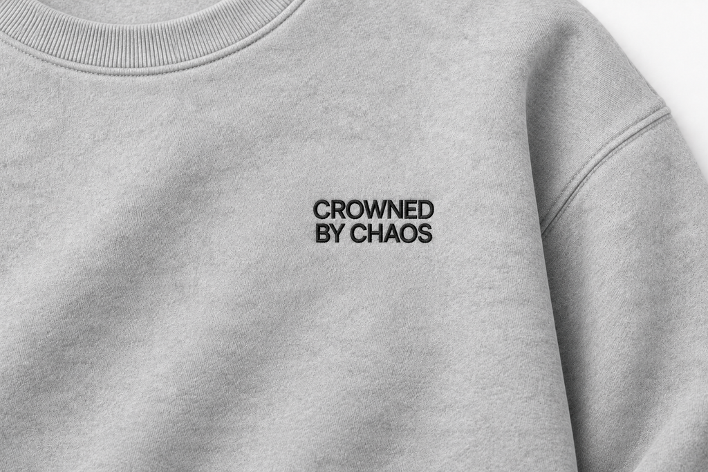 crowned-by-chaos-crewneck-heather-grey-black-wordmark-detail.png