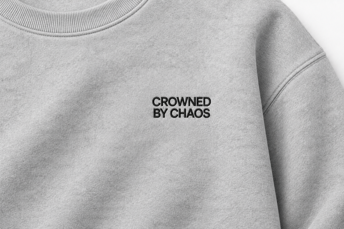 crowned-by-chaos-crewneck-heather-grey-black-wordmark-detail.png